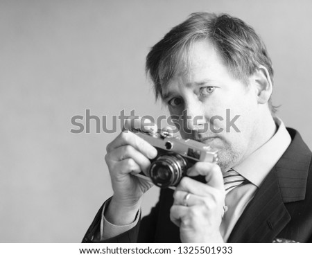 Intense man hold vintage film camera
