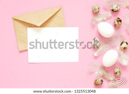 Blank greeting card. Easter composition with easter eggs and feathering on pink background. Image