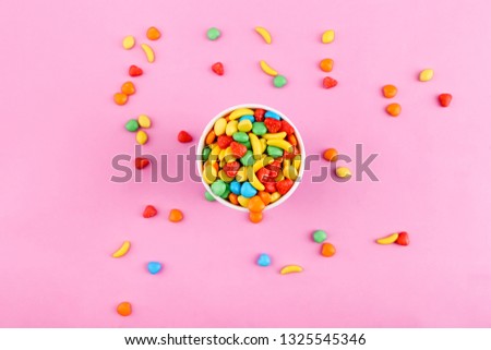 Colorful candy on pink background