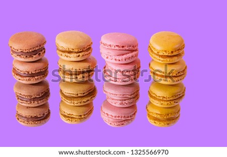 Tasty colorful macaroon homemade isolated on a mirror and a colorful background and reflections contemporary decoration