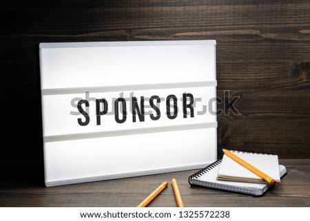 Sponsor concept. Text in lightbox. Wooden office table
