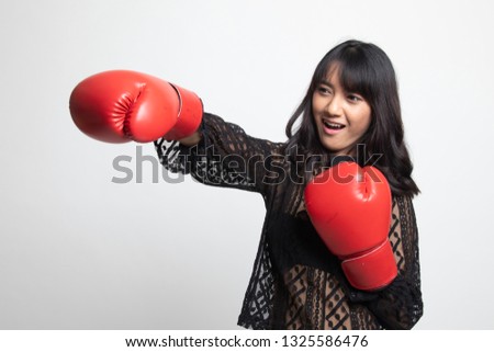 Young Asian woman with red boxing gloves on white background