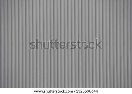 Grey corrugated iron wall with screws