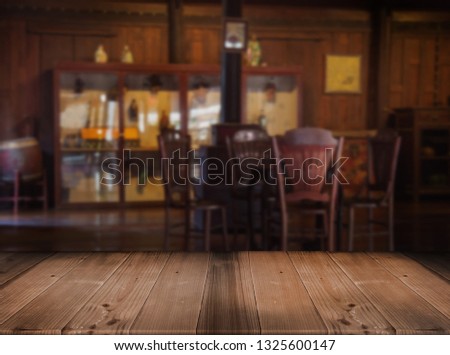 old wood tabletop counter blurred vintage living room with wood decoration Thai Style