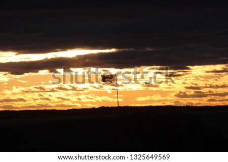 American flag being pictured during a scenic sunset