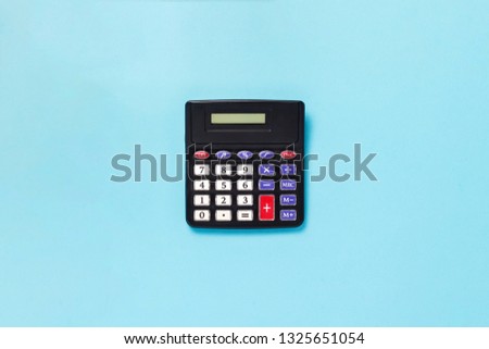 Calculator on a blue background. Flat lay, top view.