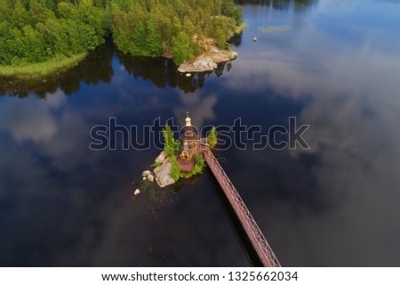View from a great height on the Church of the Apostle Andrew the First Called on the Vuoksa River on a June afternoon (aerial photography). Leningrad region, Russia