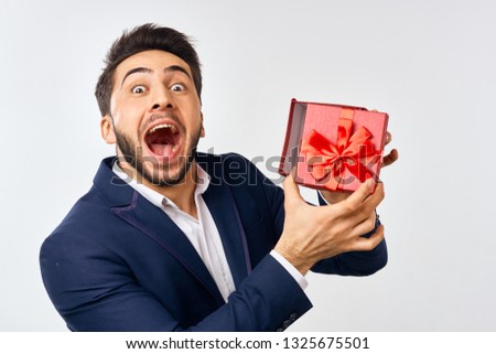   Arab man holding a box with a gift.                            