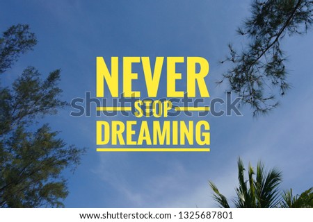 NEVER STOP DREAMING Quote on sky background. concept of freedom, dreams, ambition and motivation.

