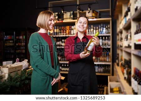 Picture of two women with bottle of wine in hand