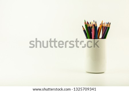 colorful of color pencils in white coffee cup.