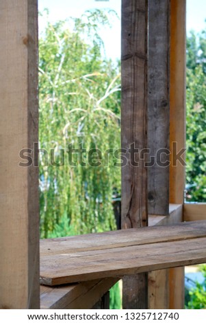 Wooden planks on wooden poles in a construction site in the summer and daytime