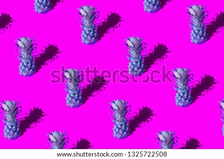 Neon pineapple fruits pattern on pink and blue background. Summer concept