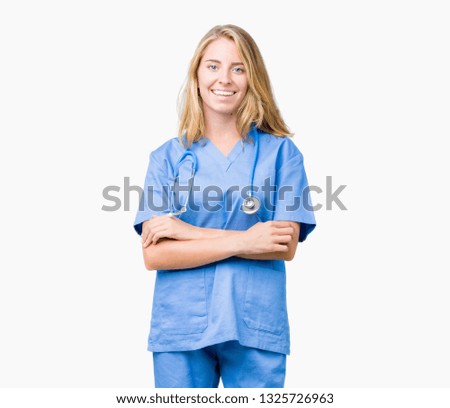 Beautiful young doctor woman wearing medical uniform over isolated background happy face smiling with crossed arms looking at the camera. Positive person.