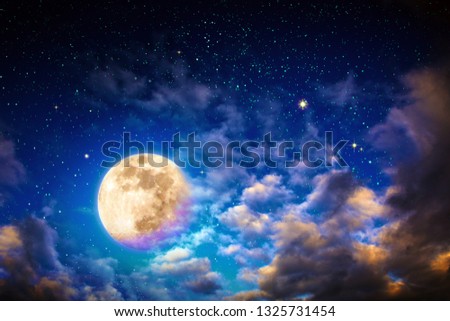 Dark night sky with stars with big clouds and full moon.