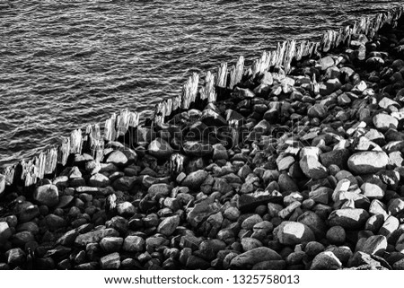 fence and stones stand along the edge of the canal