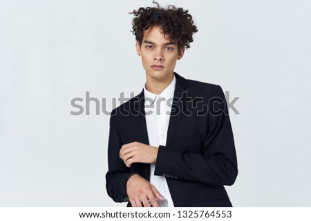 Cute elegant man in a suit on a gray background office worker