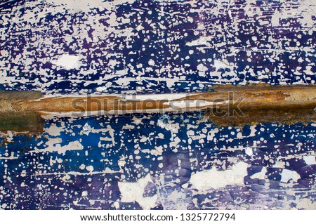 Picture of a cracked resin texture of the hull of an abandoned boat at Sanur Beach in Bali, Indonesia