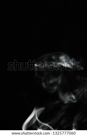 White smoke on black background. 