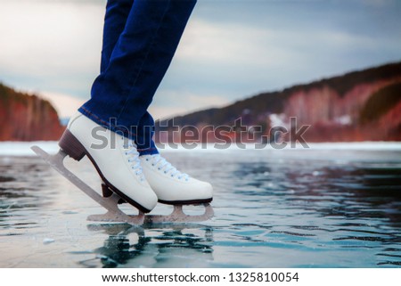 ice skater legs on the ice on the lake or river