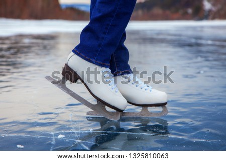 ice skater legs on the ice on the lake or river