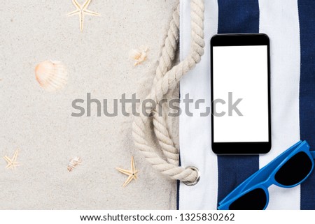 Smartphone screen on sandy beach, summer vacation mockup.