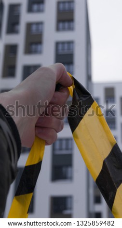 yellow striped ribbon in hand