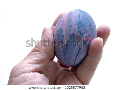 Fancy Egg in hand isolated on white background.