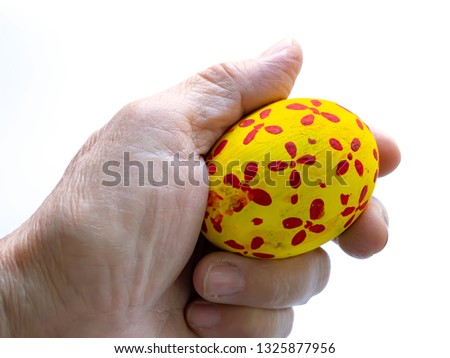 Fancy Egg in hand isolated on white background.