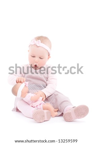 Sweet ittle girl play with doll. Over white background