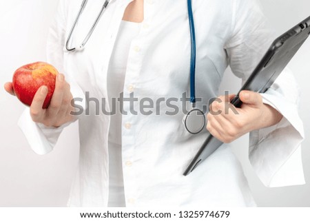 doctor with stethoscope and apple