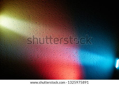 Wide rays of blue and yellow separated by red glow