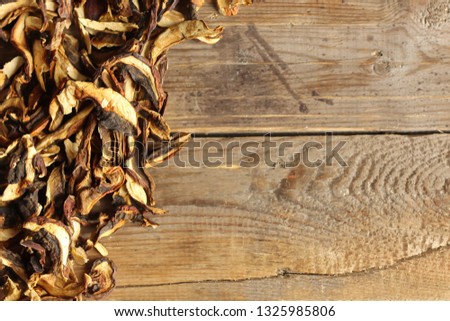 Dried mushrooms on a wooden background. Copy space, horizontal orientation, flat lay