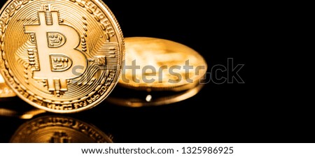 Golden Bitcoin on black background. Close-up, macro shot. New Virtual Money 
