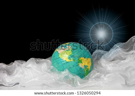 planet earth trapped in a sea of plastic waste that is bad for the environment with black background stock image stock photo