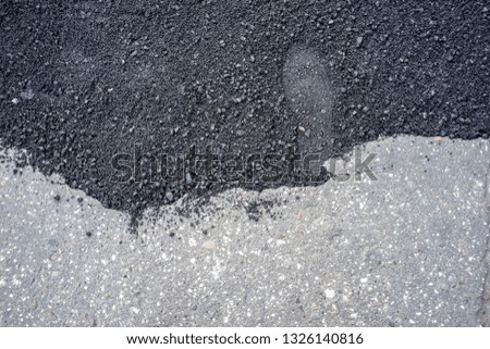footprint in fresh asphalt