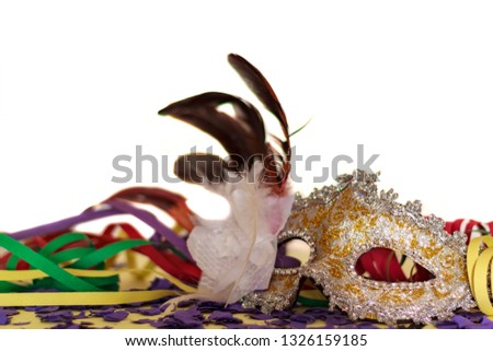 Carnival party concept. Mask, Streamers And Confetti against white background