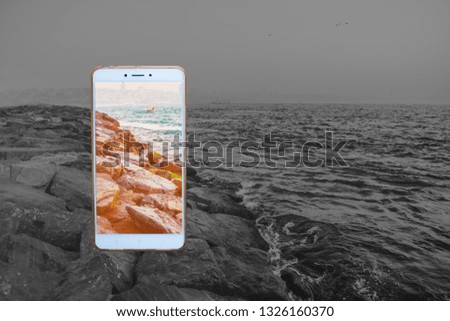 Transparent phone on the sea background. White smartphone