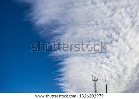 Tower with lightning outlets on the background of the sky with clouds