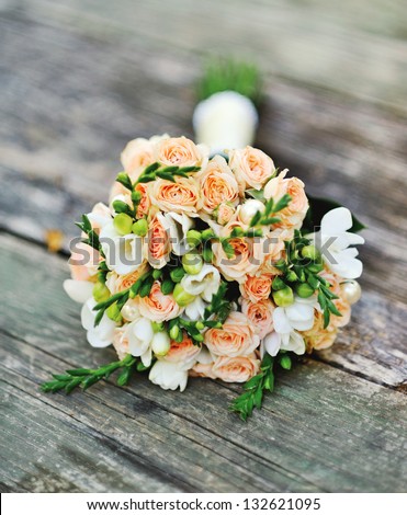 Wedding bouquet on a wood surface Royalty-Free Stock Photo #132621095