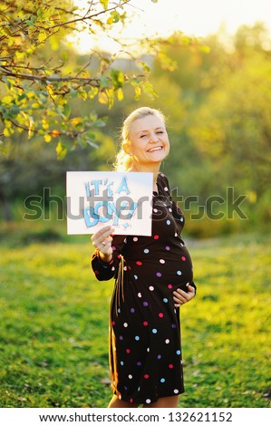 beautiful pregnant young woman outside, warm sunny picture