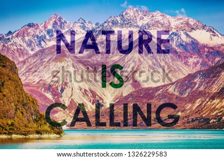 NATURE IS CALLING motivational quote on mountain range landscape sunset background. Outdoors inspiration to go travel in nature. Snow capped peaks of Alaska. USA.