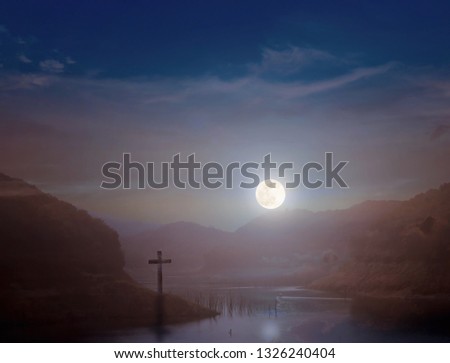 Crucifixion concept: the cross at night with the moon