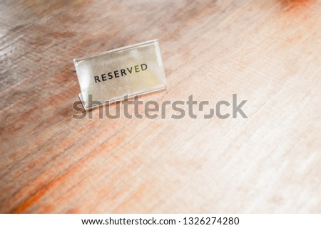 Reserved label the blank menu frameon wooden table cafeteria blurred background can inserting the text.