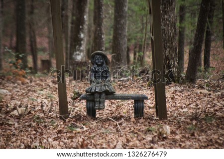 Stone Bench and Sculpture of Girl Sitting in the Gloomy Autumn Woods