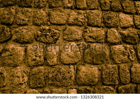 Golden dark walls. Wallpaper and background for modern design. Medieval masonry. Stonework