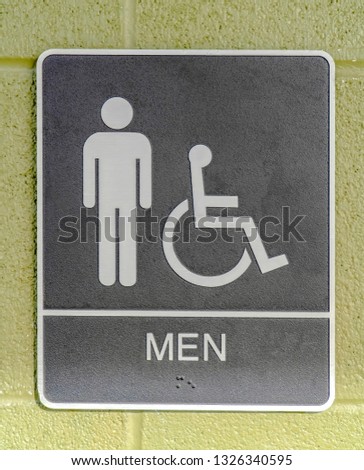 Men restroom sign posted on a green wall