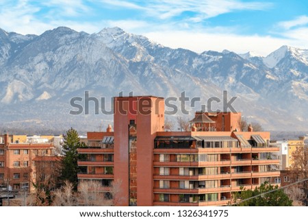 Buildings against Wasatch Mountain and cloudy sky