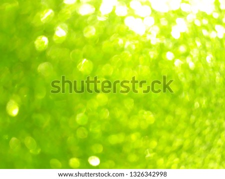 Light green and yellow color of the background blurred with flare and bokeh,  overexposed    