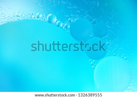 Blue and cyan colored creative abstract background with mixed bubbles.